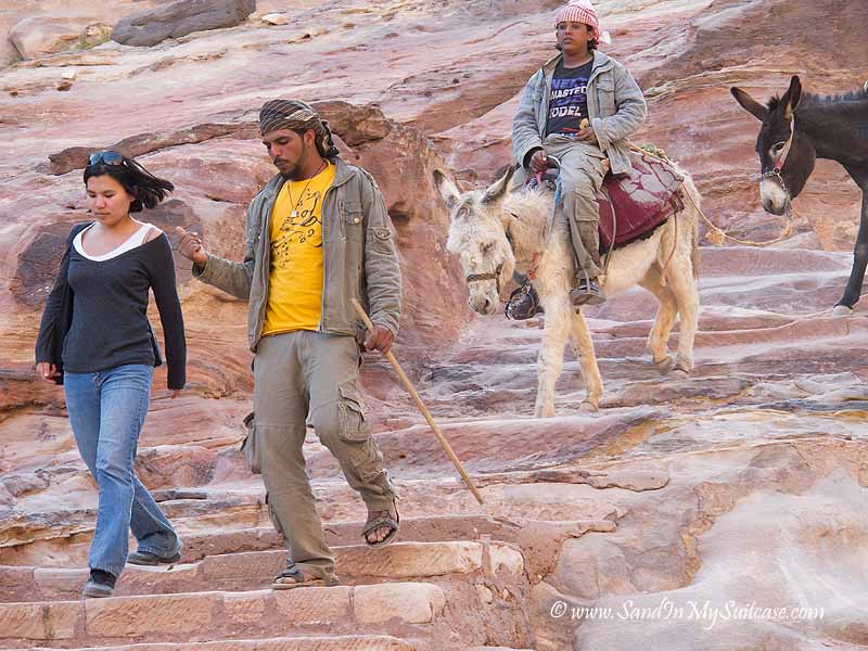 ancient Petra - donkeys climb down steps from Monastery