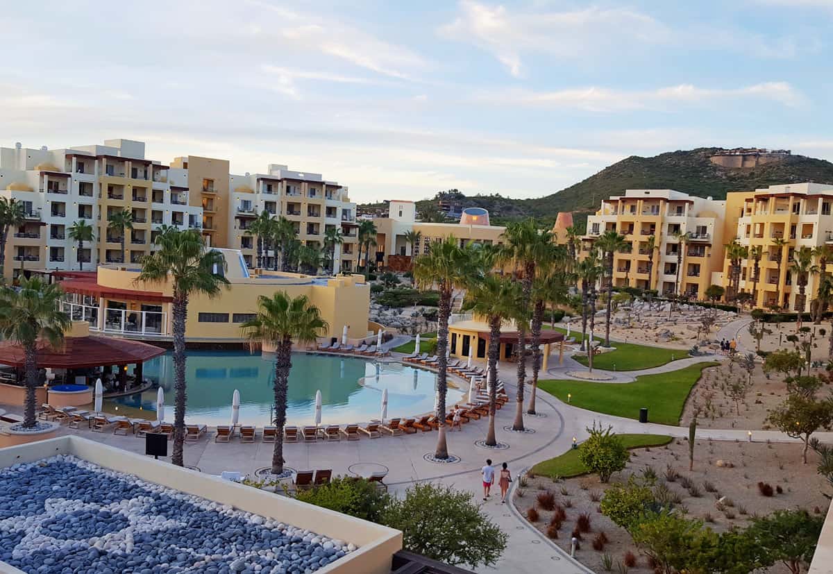 Gold and cream buildings of Pueblo Bonito Pacifica at dusk