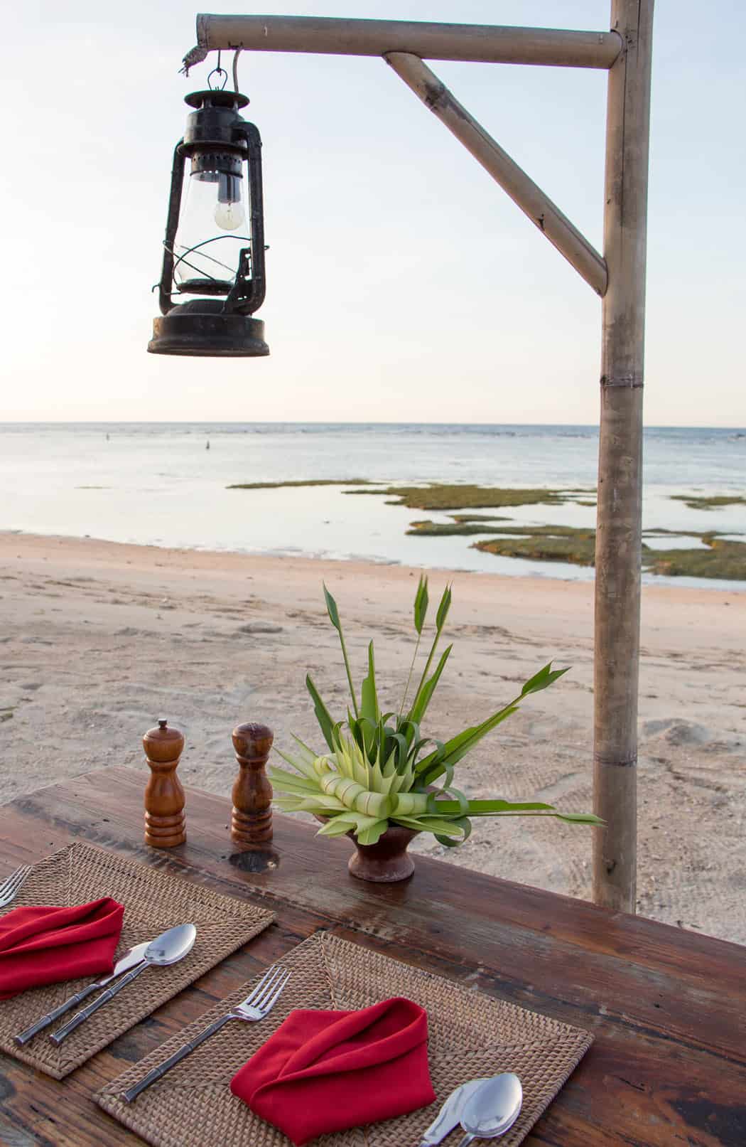 Table on the beach set for two at Tugu Lombok