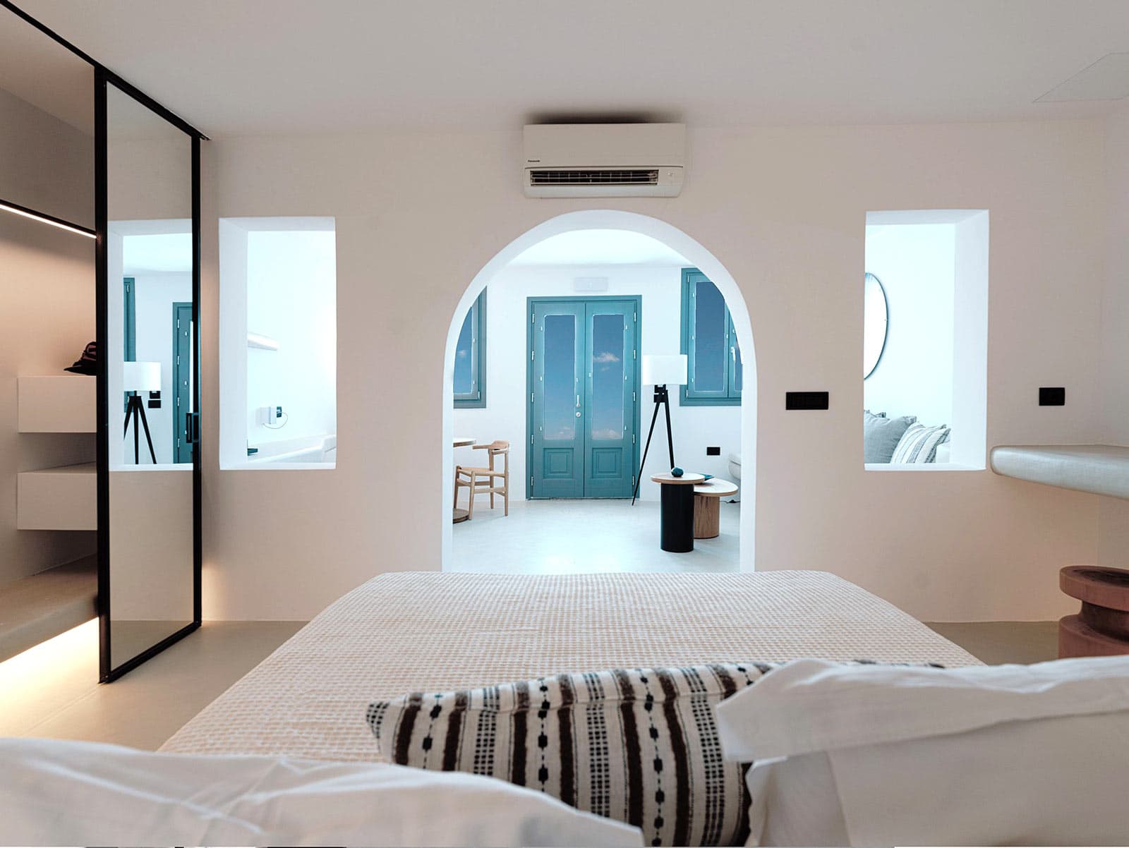 Inside airy white-washed cave suite in Santorini