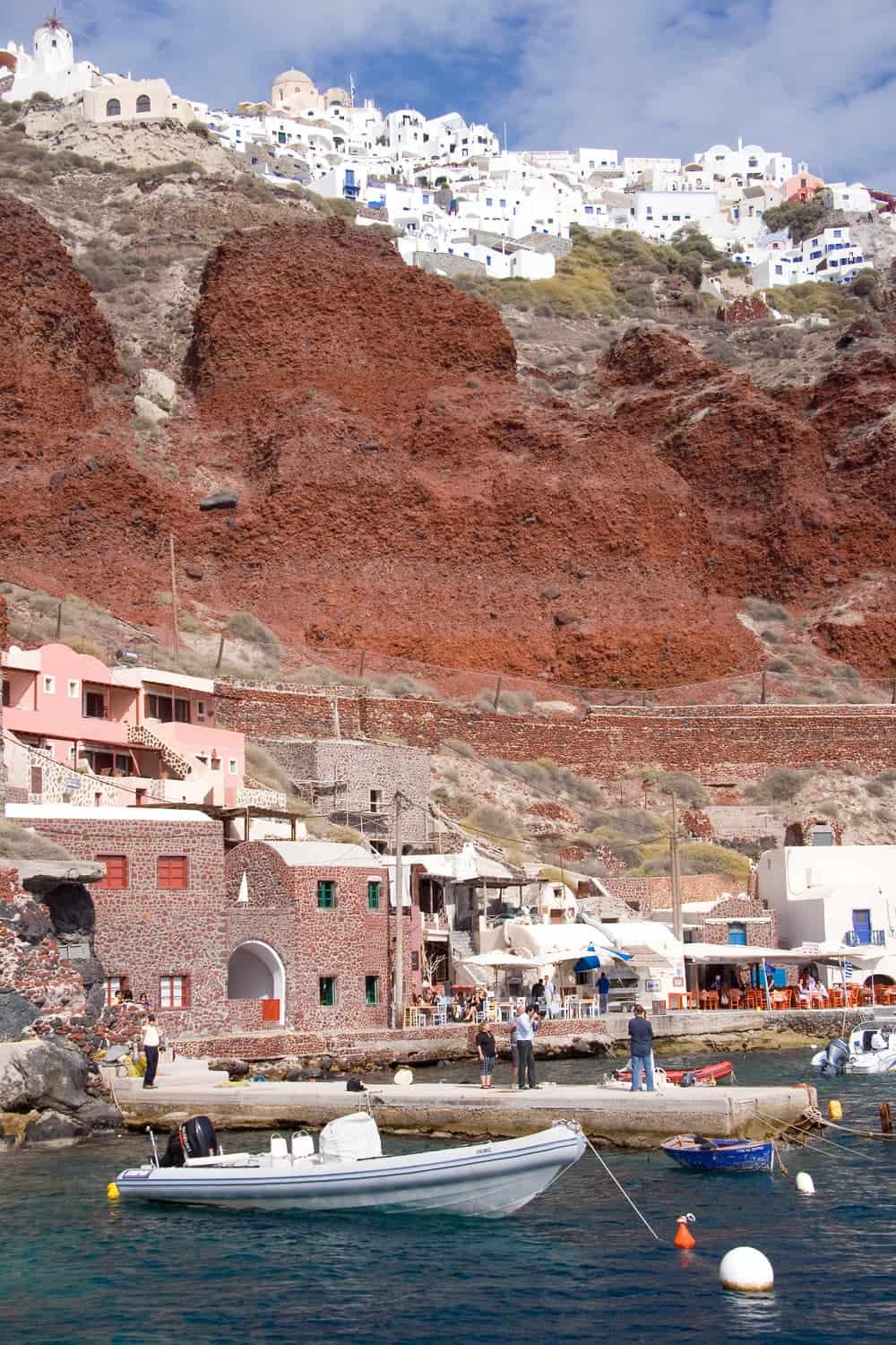 White houses of Oia perched above Santorini's red cliffs