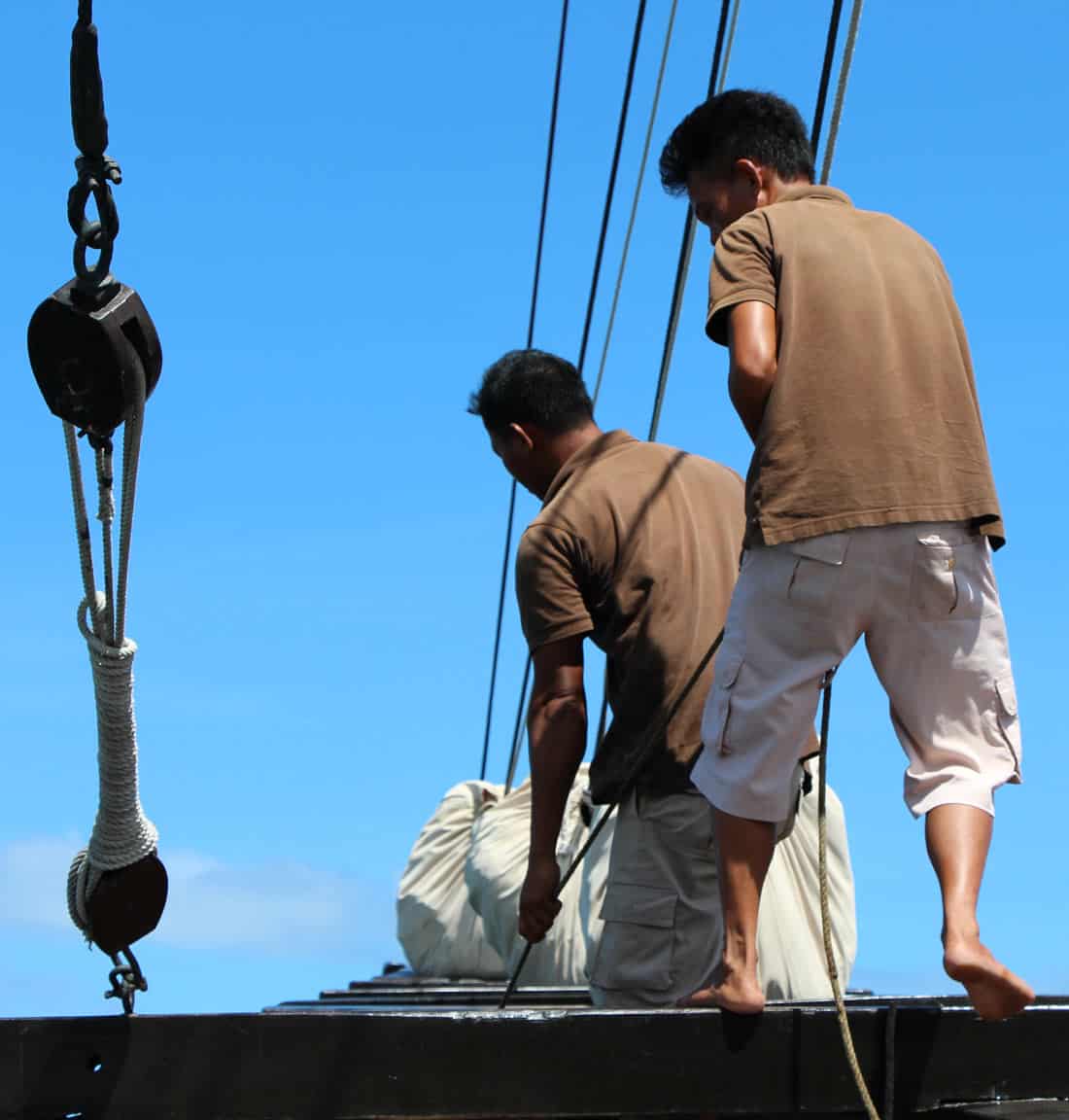 Crew work the ropes and sails on the Alila Purnama phinisi