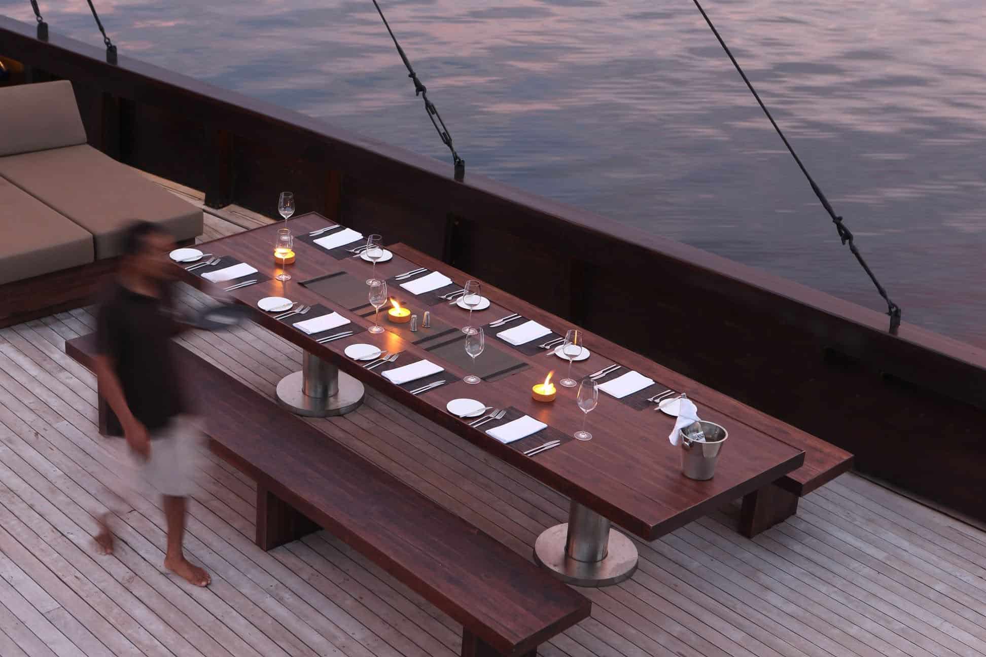 Dinner table on yacht set with candles