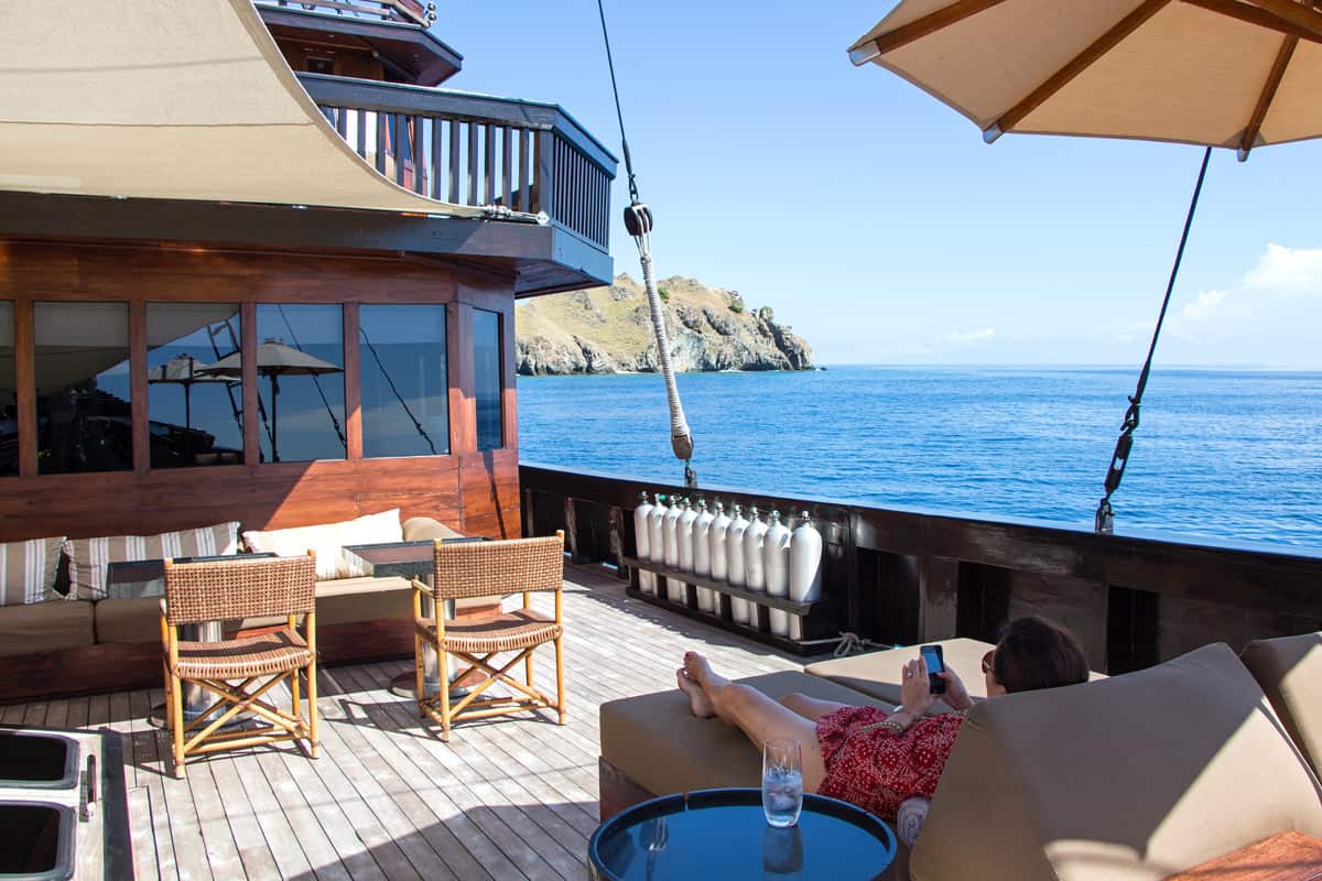 Woman relaxes on deck of a yacht