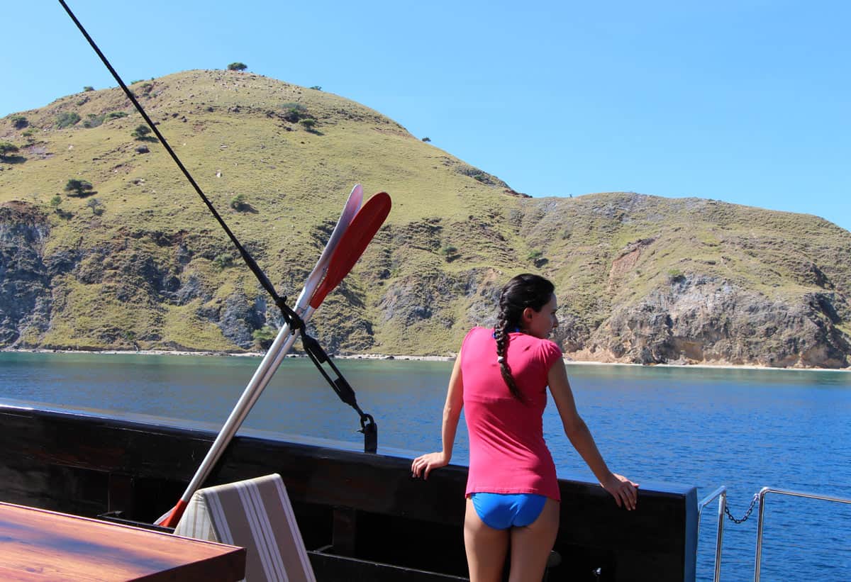 Woman in pink T-shirt gazing out from the Alila Purnama yacht