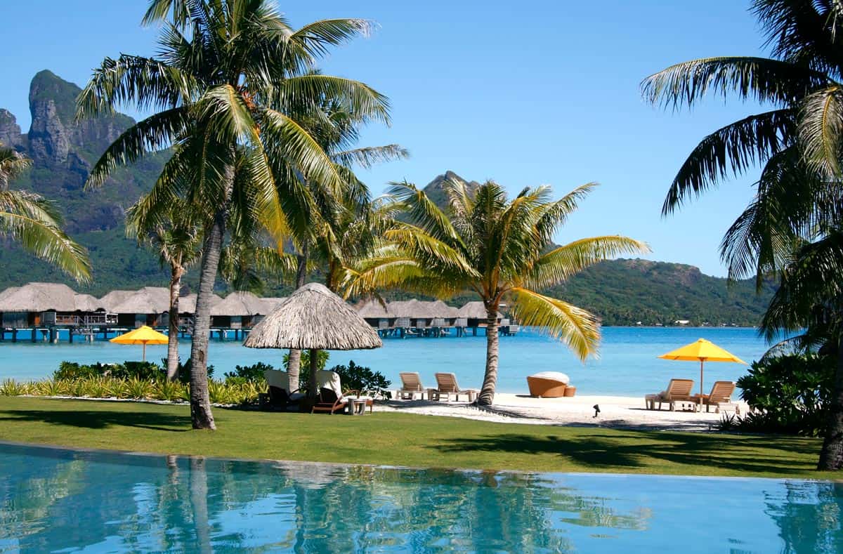 Pool with a view of beach and overwater bungalows