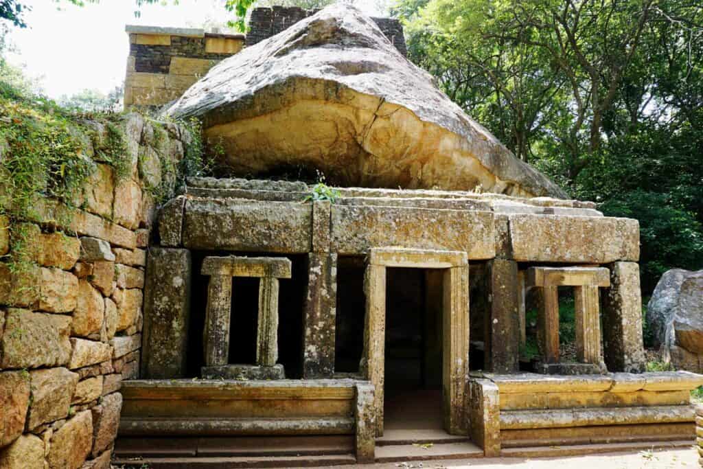 An ancient monk’s stone dwelling tucked beneath a rock at Mihintale