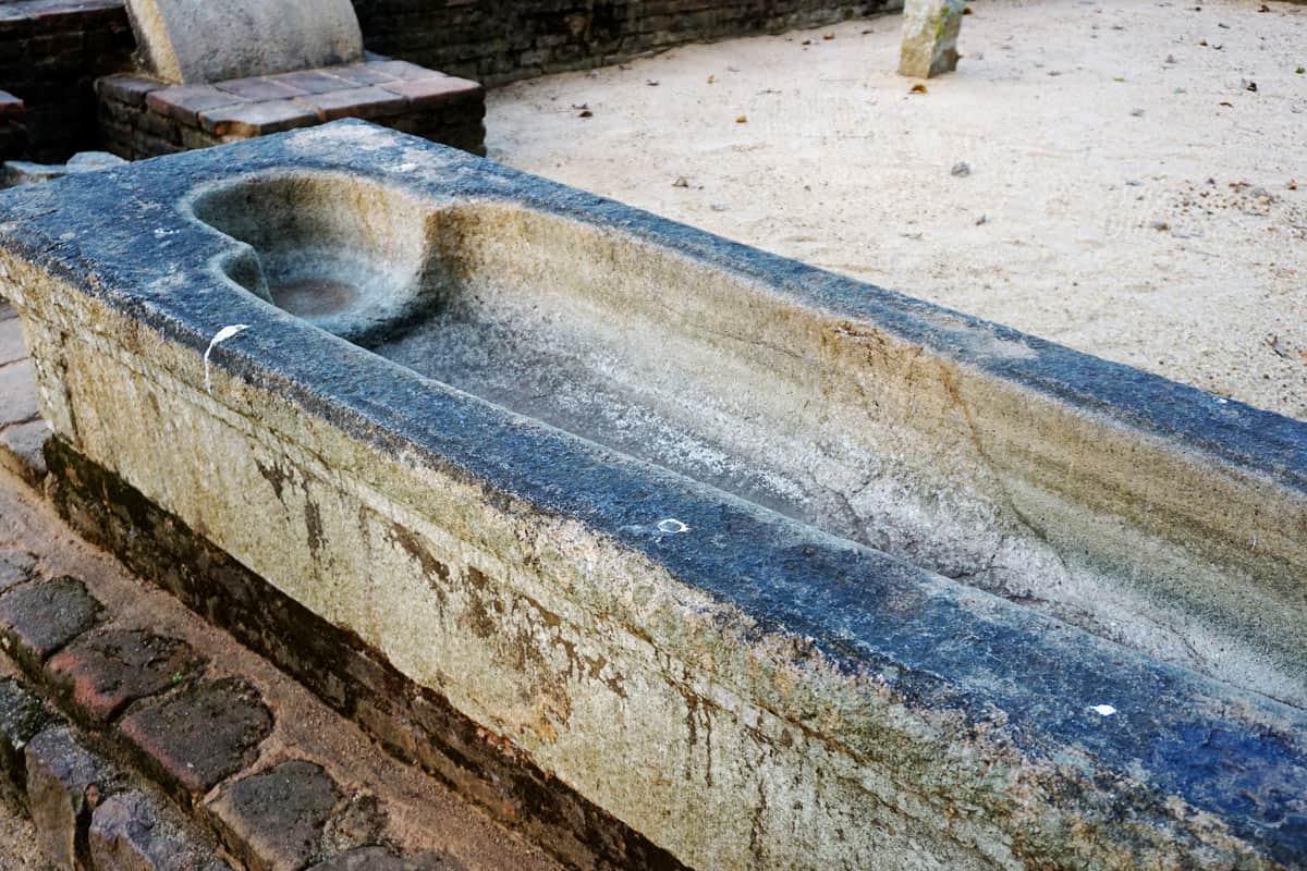 Ancient stone healing bath at Mihintale, where patients lay immersed in medicinal oils