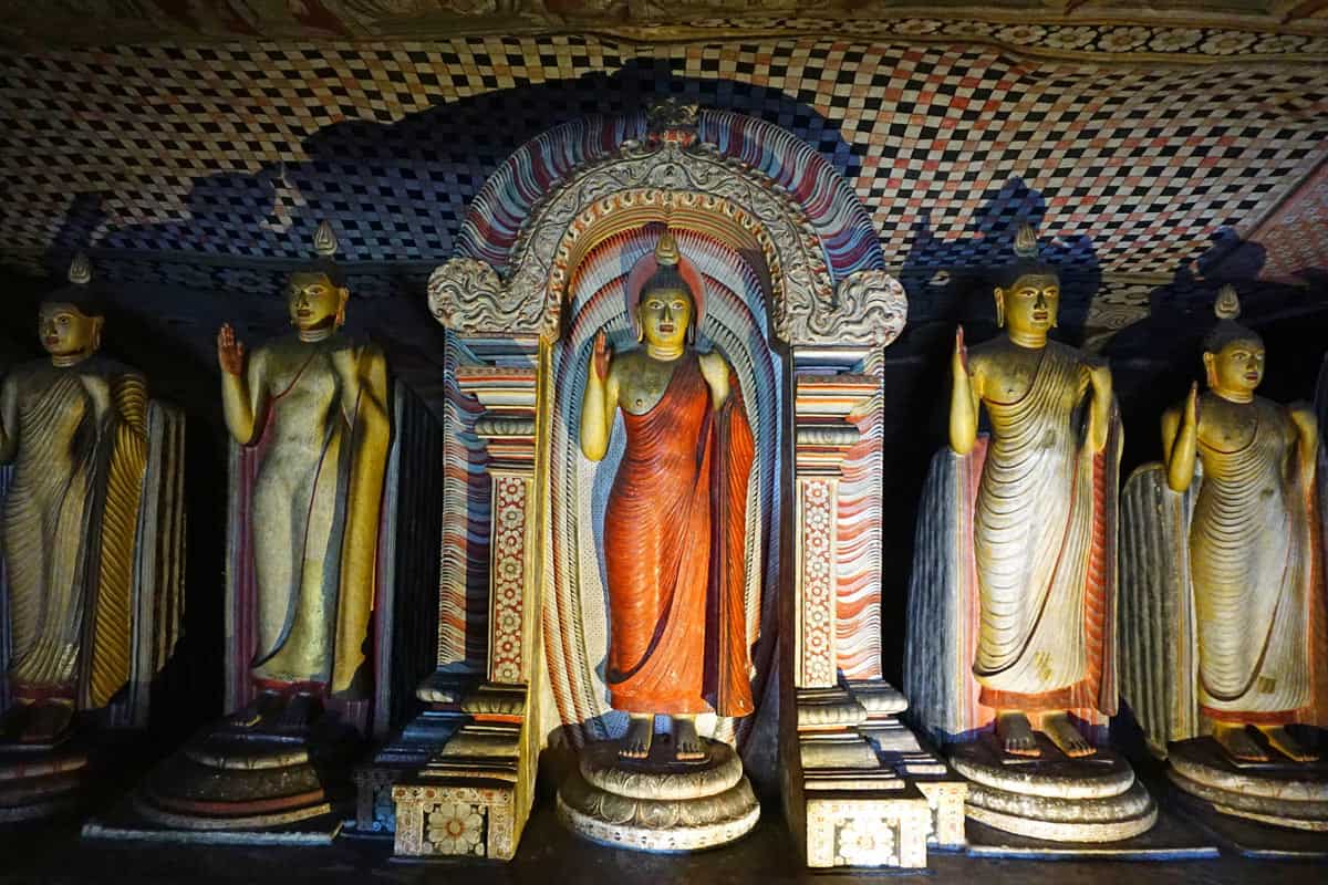 Red-and white-robed Buddha statues inside Dambulla cave complex