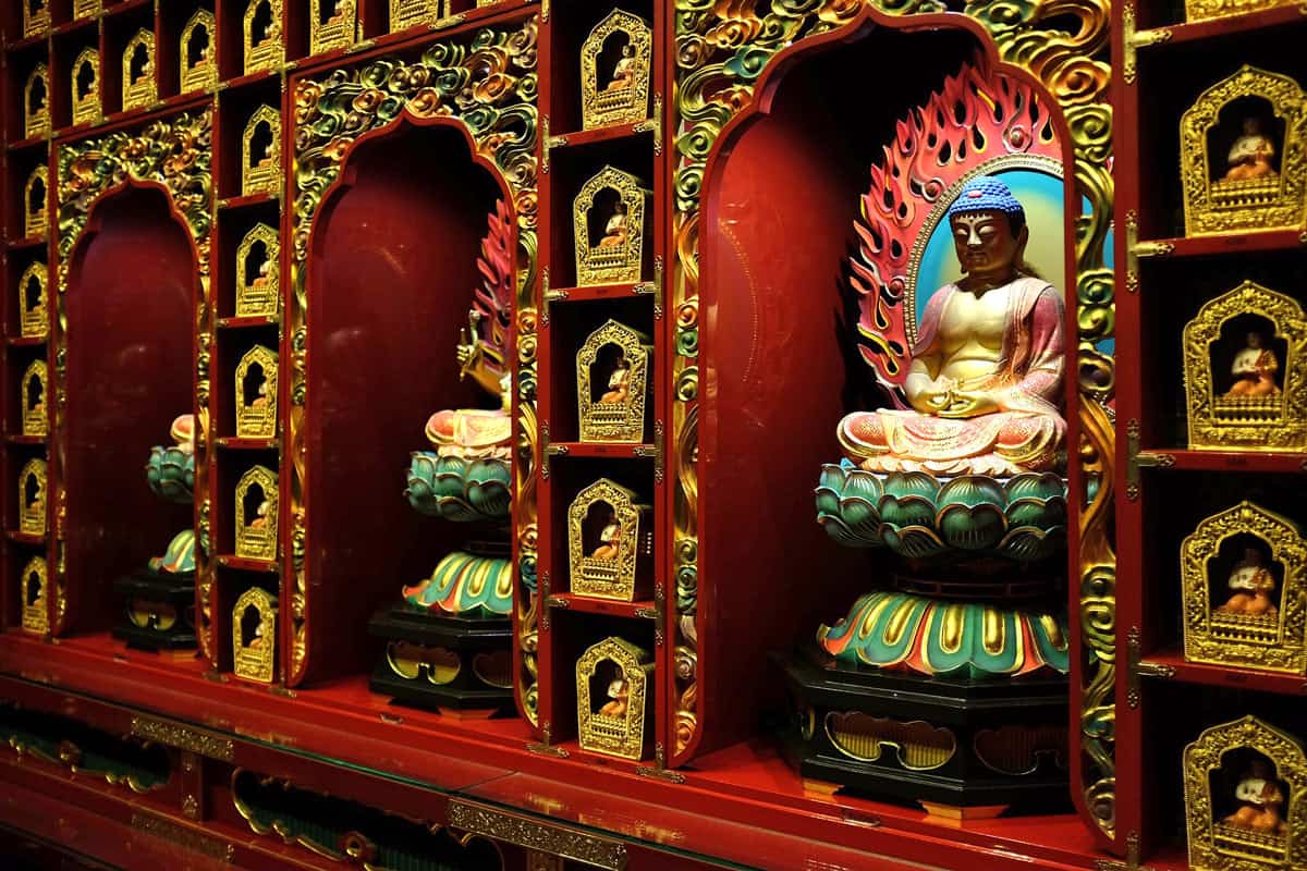 Red lacquer shelves with Buddha statues inside Kandy's Temple of the Tooth