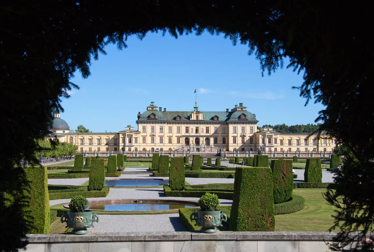 View of Drottningholm Palace through a hedge arch