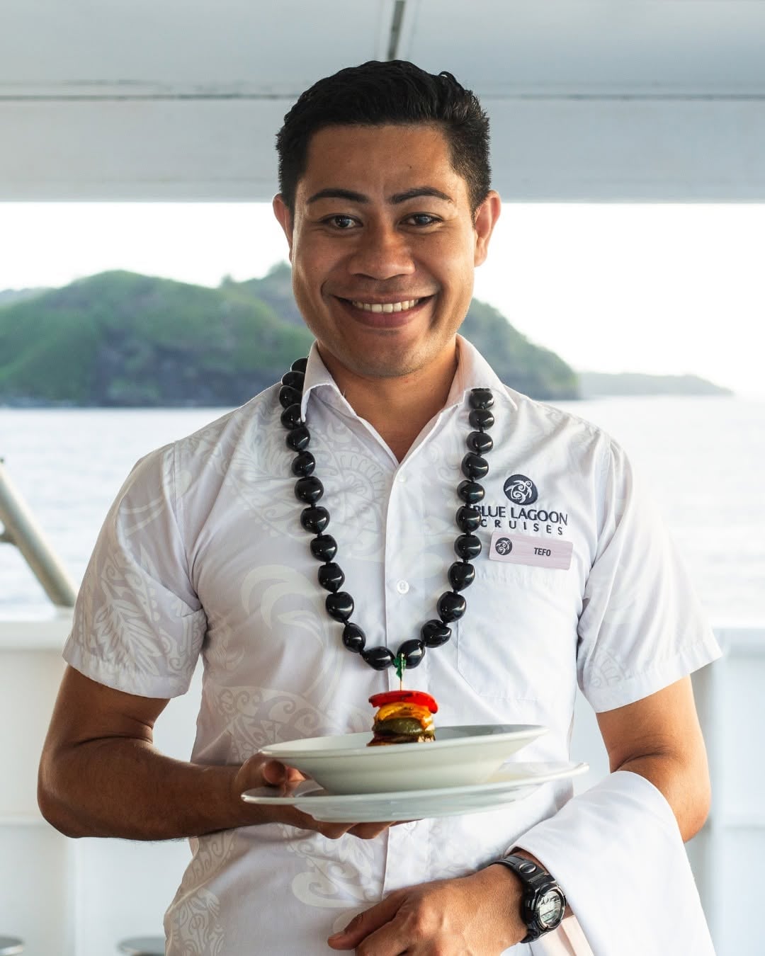Smiling waiter on Blue Lagoon Cruises