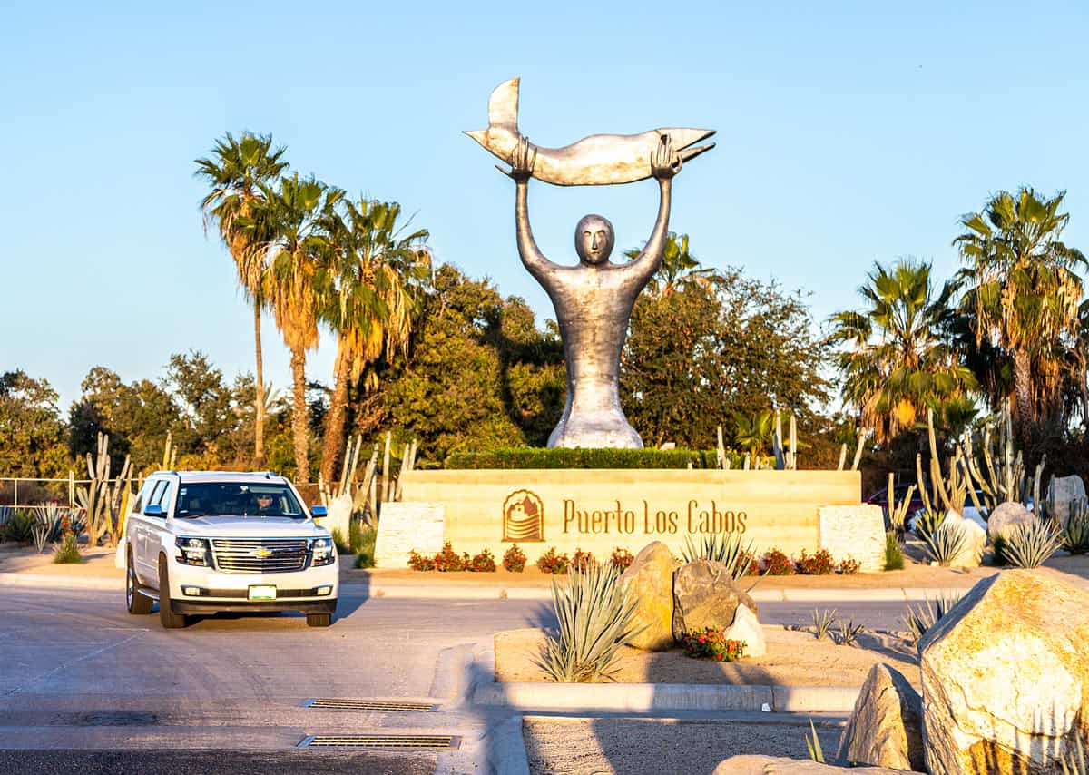 White airport transfer SUV arriving at Puerto Los Cabos at sunset