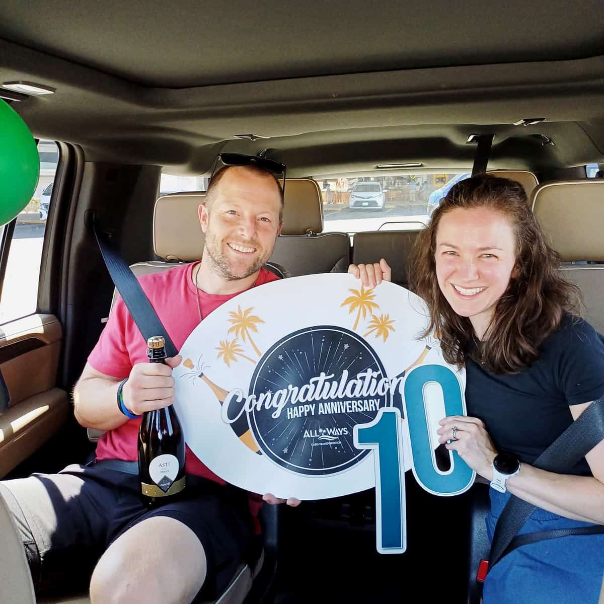 Couple celebrating their 10th anniversary during an All Ways Cabo Transportation private transfer from the airport