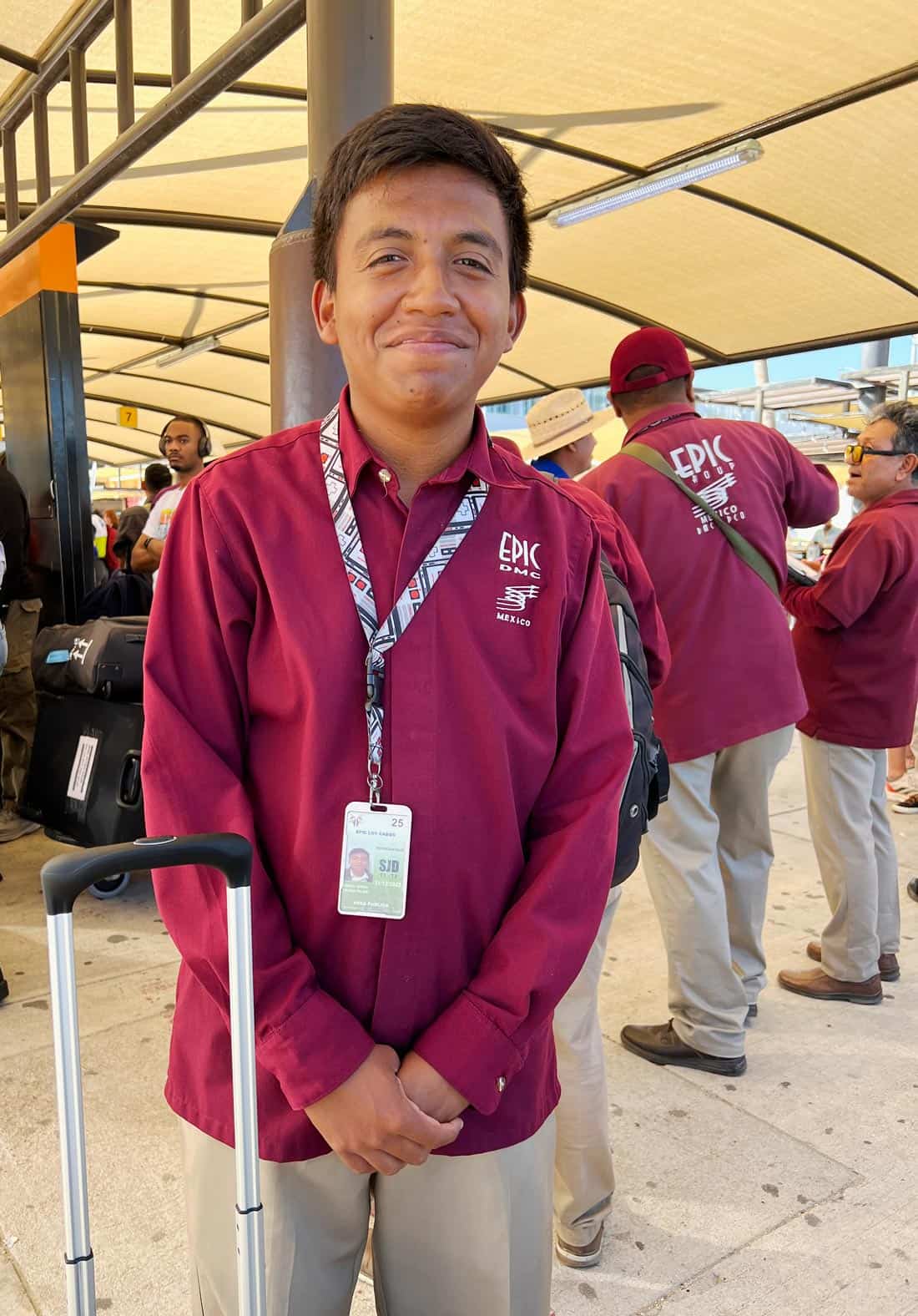 Epic Los Cabos airport greeter in burgundy uniform at Los Cabos International Airport