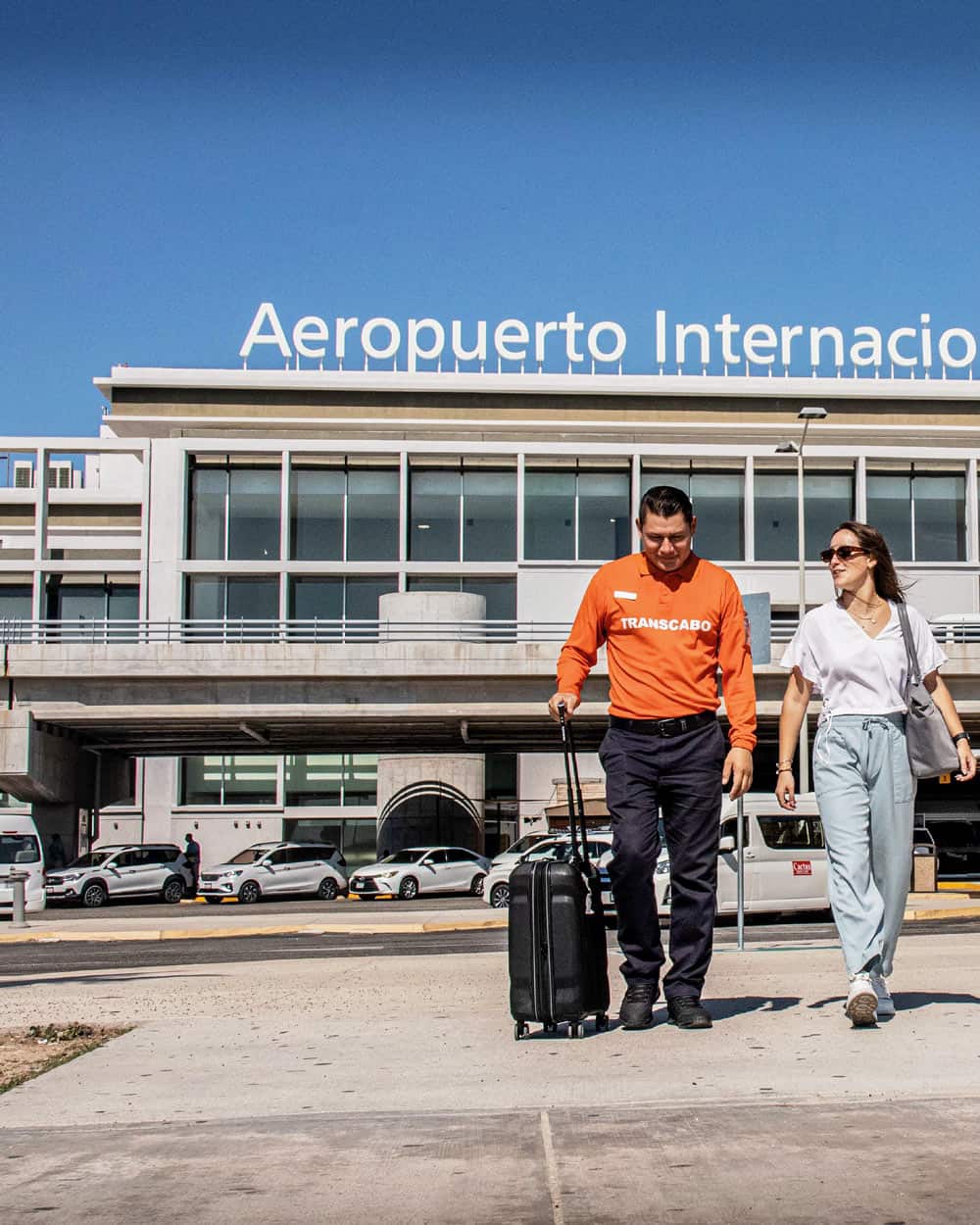 A shuttle driver picking up a passenger at the airport in Cabo