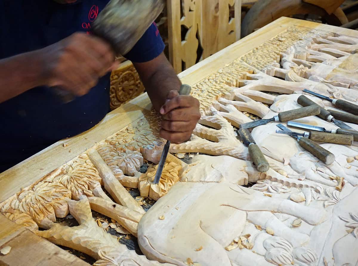 Sri Lankan artisan carves an elephant from wood.