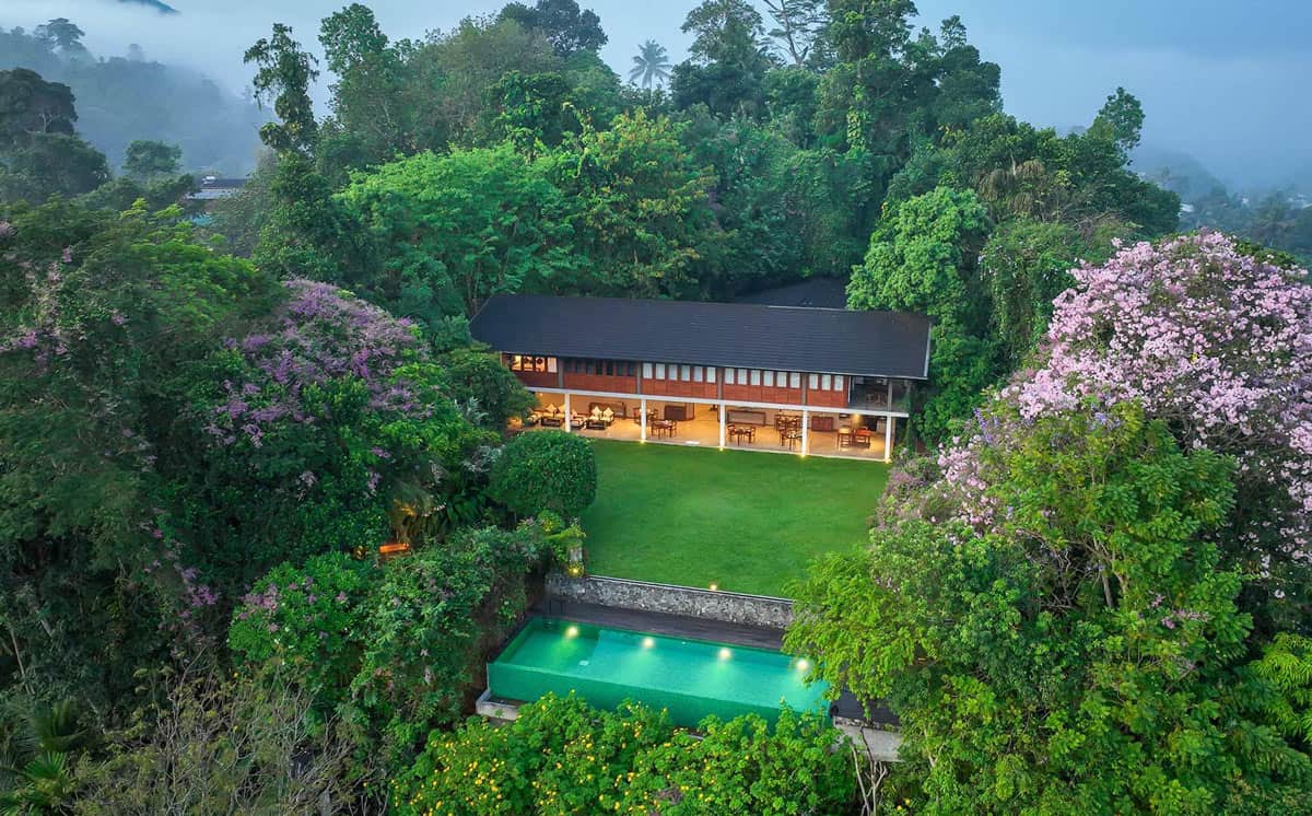 Leafy lawns and green pool in front of Kings Pavilion hotel in Kandy