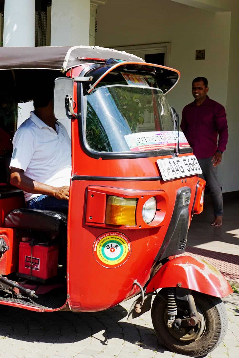 Red tuk-tuk with driver