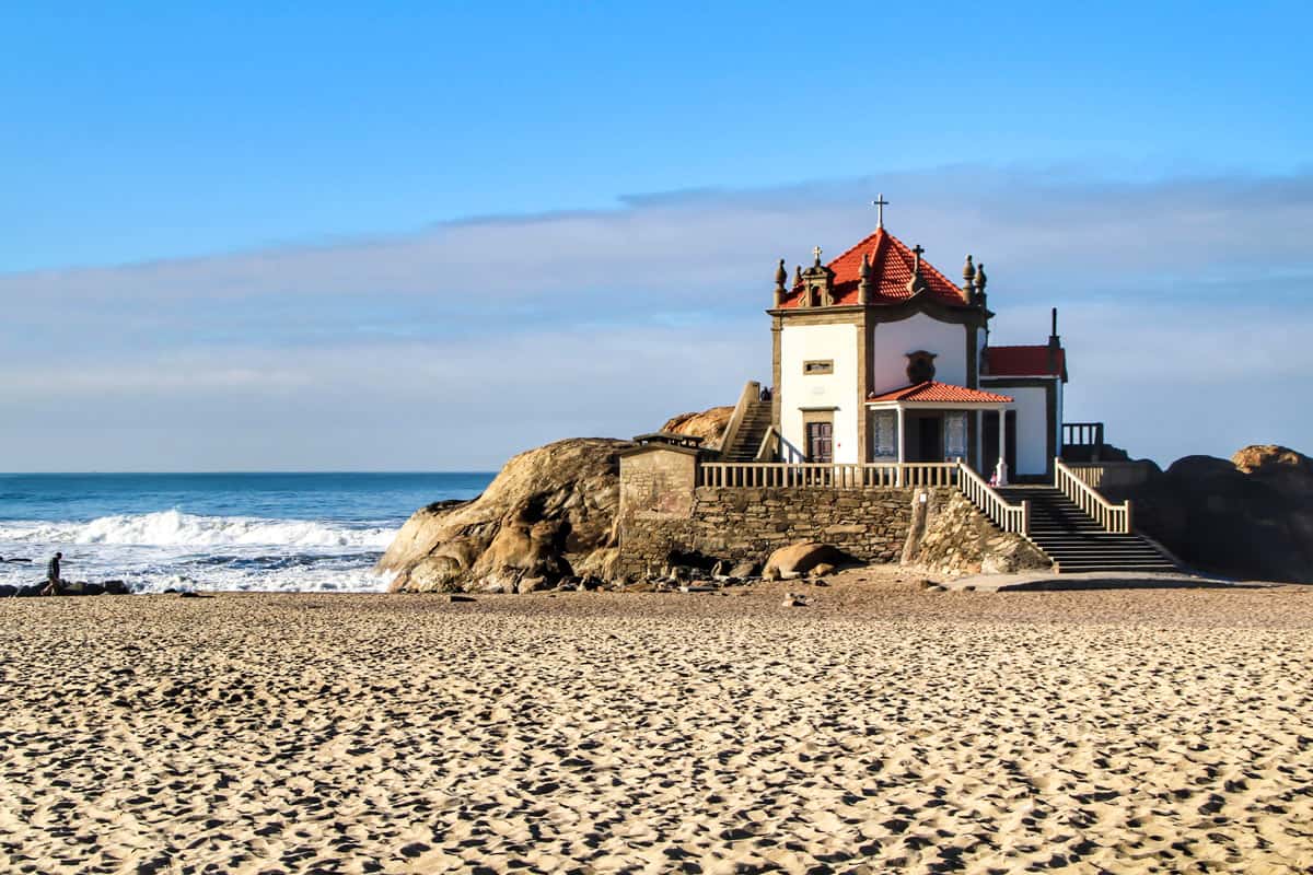 Portugal's tiny centuries-old chapel (Capela do Senhor da Pedra) is built on a rock on the Atlantic coast.
