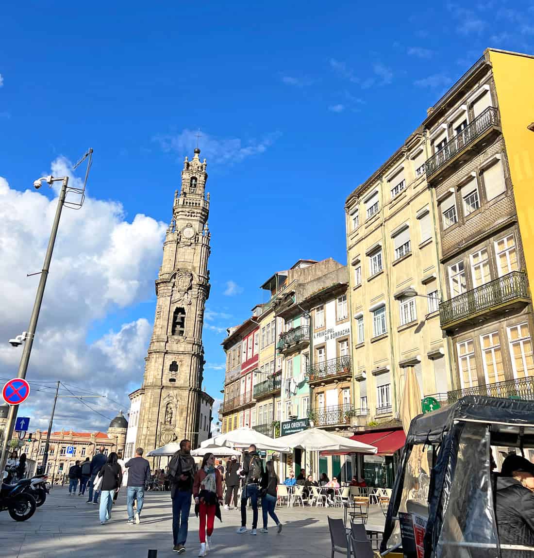 Visitors wander around at the base of Porto's Clerigos Tower.