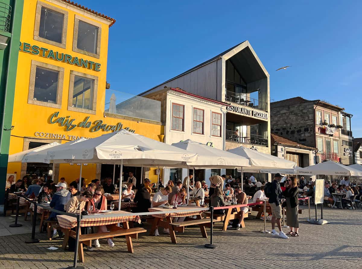 Visitors at outdoor cafes on the Gaia riverfront at sunset