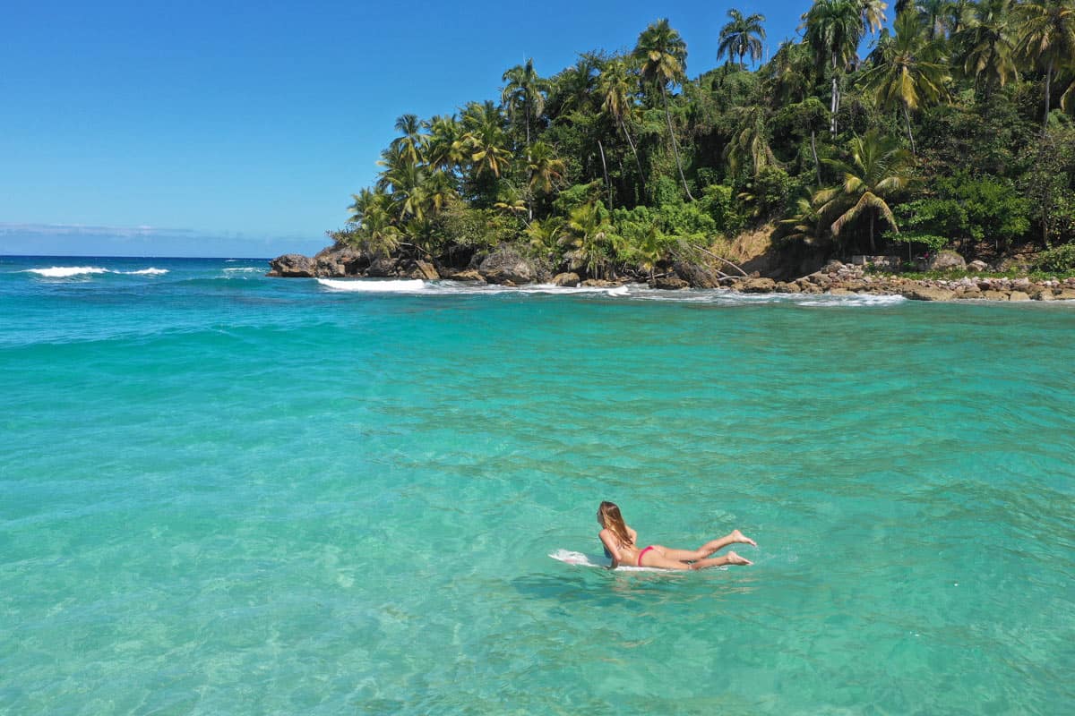 Uncrowded beach coves? Yes! Girl on a board in the Caribbean