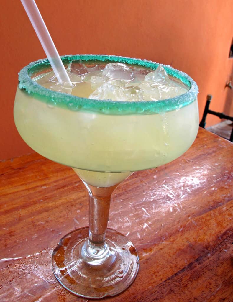 Giant lime margarita with a green sugar-rimmed glass at Tacos Gardenias in Cabo San Lucas