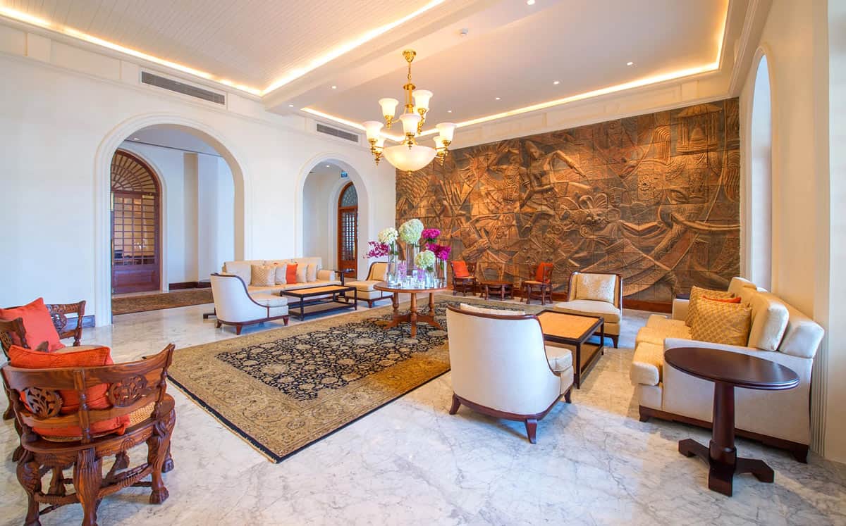 Elegant lounge at Galle Face Hotel in Colombo, with marble floors, carved wall art and colonial-style furnishings