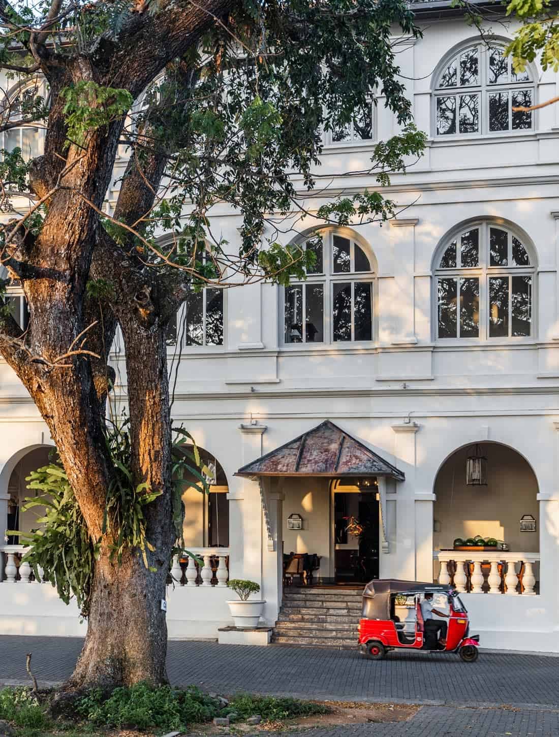 Elegant white exterior of Amangalla in Galle, with arched windows