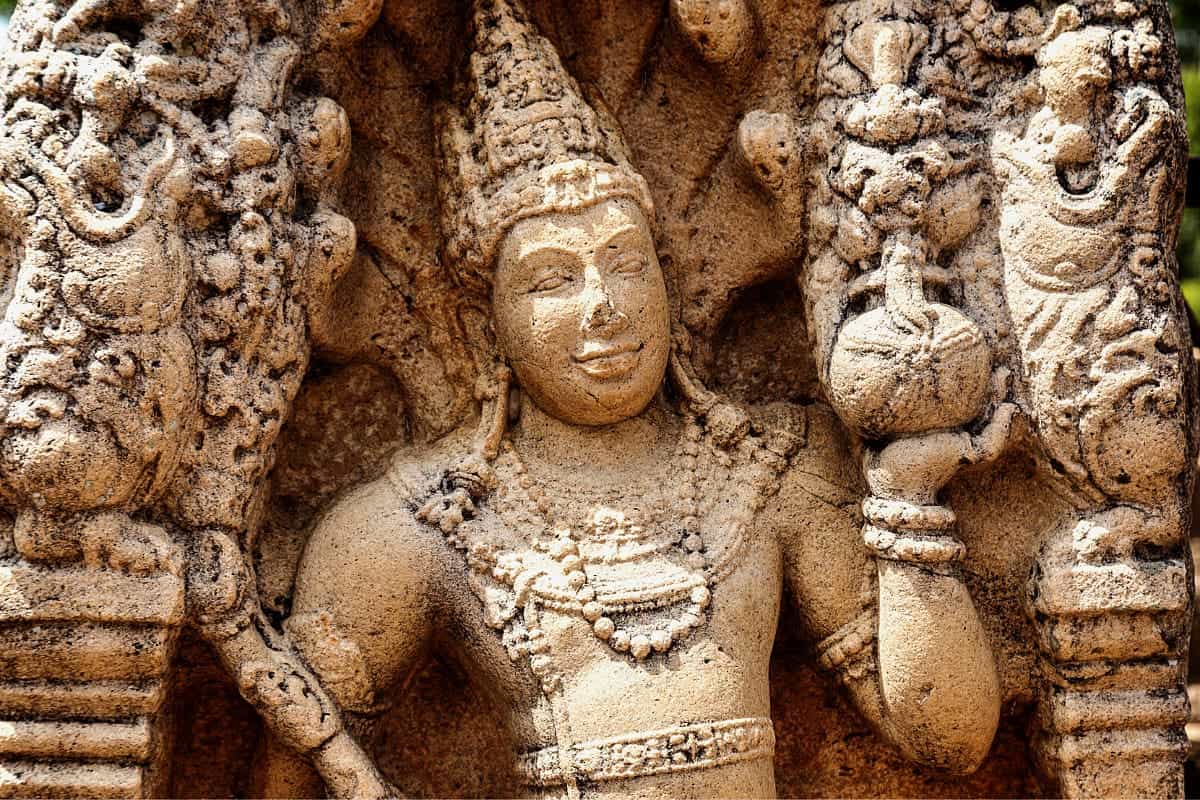 Close-up of an intricately carved ancient stone figure in Anuradhapura, Sri Lanka