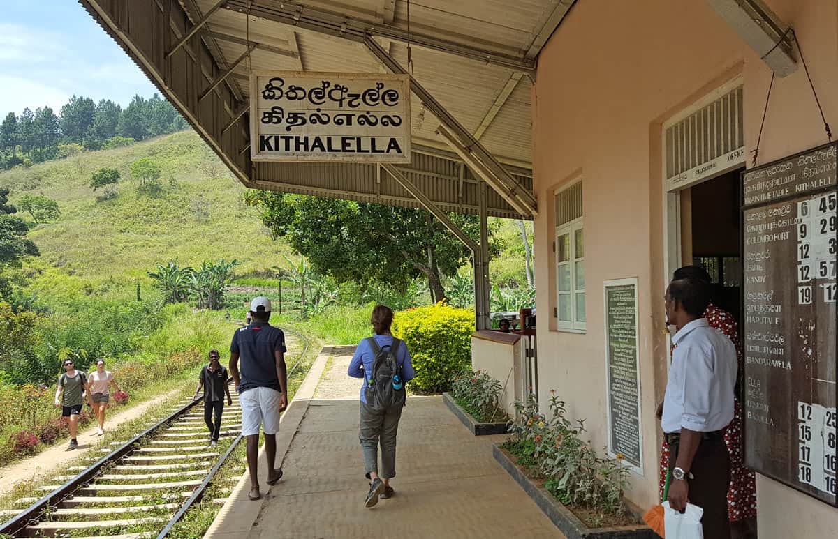 Kithalella train station near Ella, Sri Lanka, with hikers walking along the train tracks