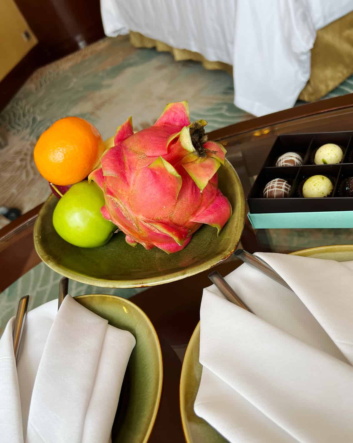 Welcome amenity of dragon fruit, apple and orange with a box of chocolates in our Shangri-La Bangkok room
