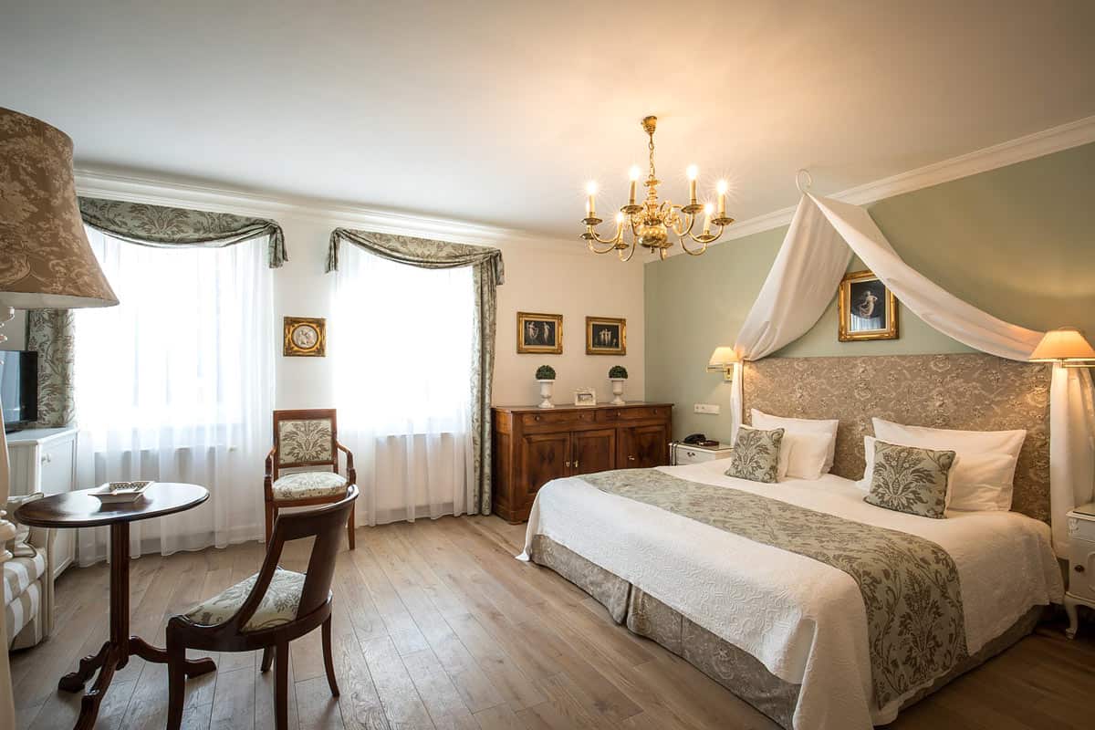 Belle Epoque Hotel guest room with wood floors and large bed