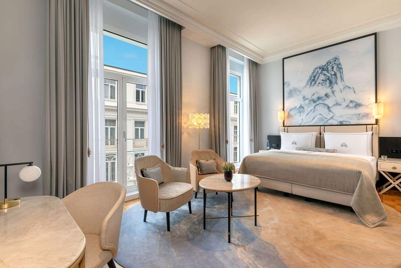 Guest room at Hotel Atlantic with king bed and soothing beige curtains and decor