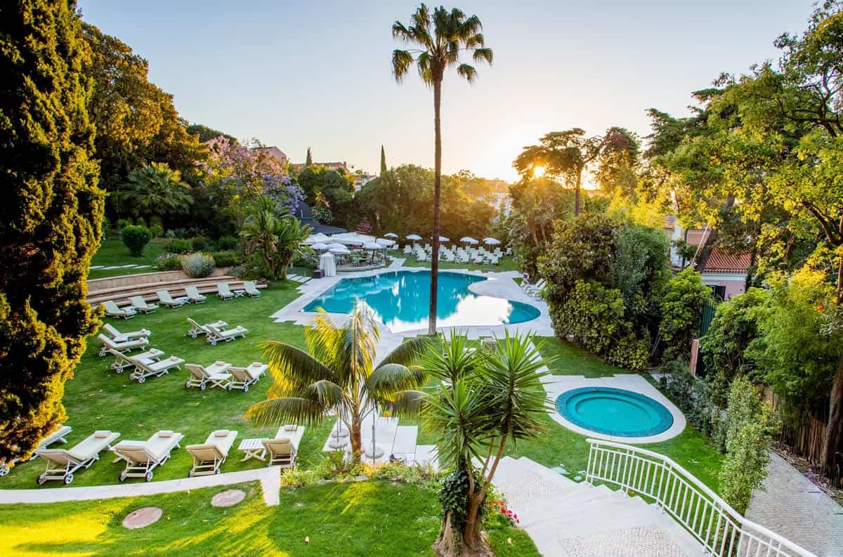 Lush subtropical gardens surround the Olissippo Lapa Palace's sparkling pool.