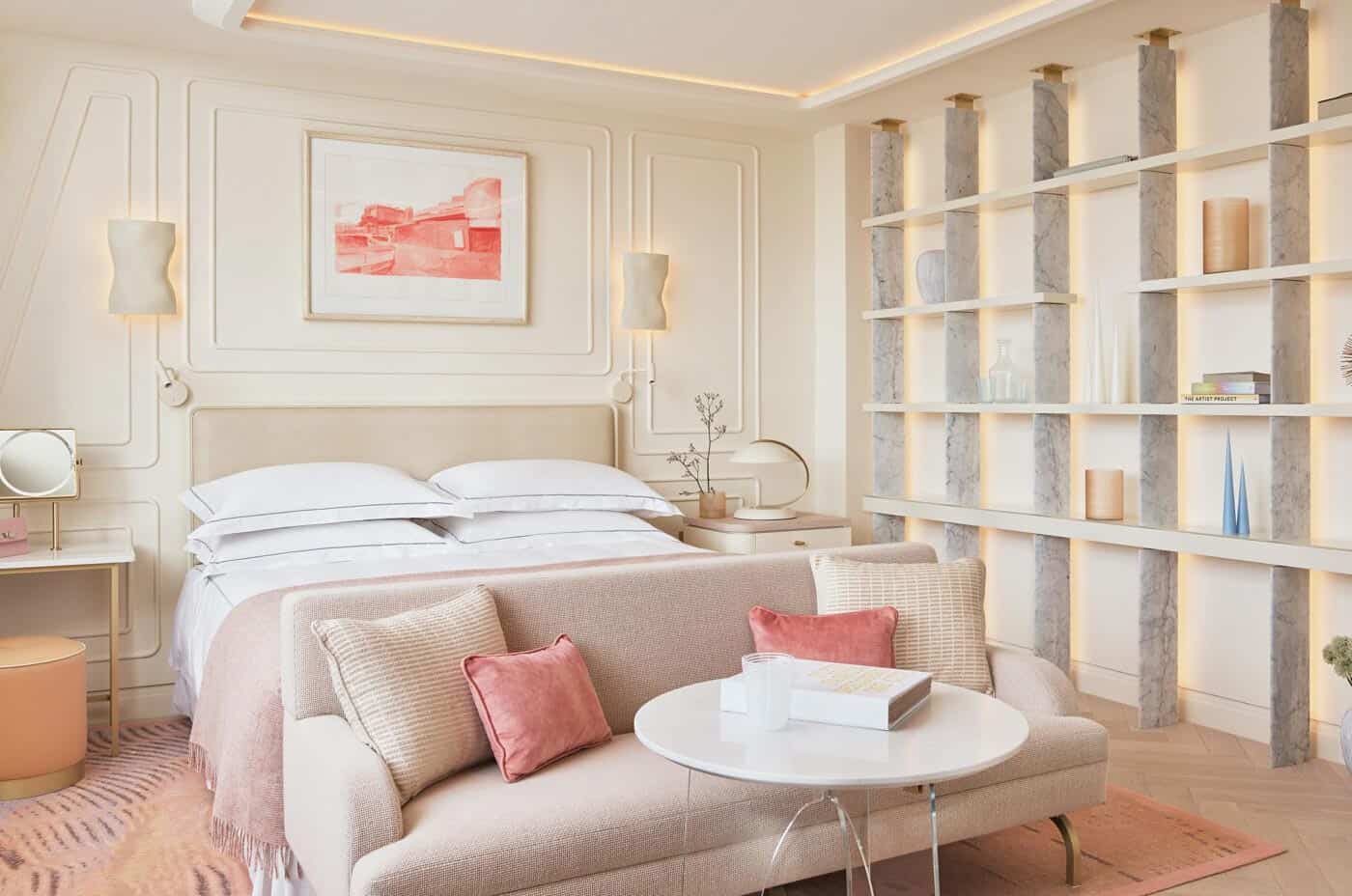 One Aldwych guest room with pink cushions and pink carpet