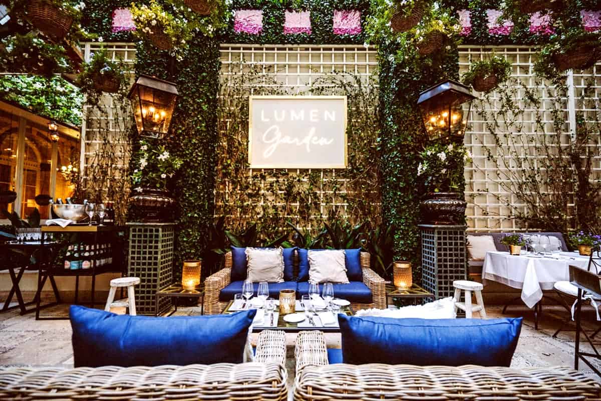 Lumen Garden at The St. Regis Rome with blue couches and loveseats