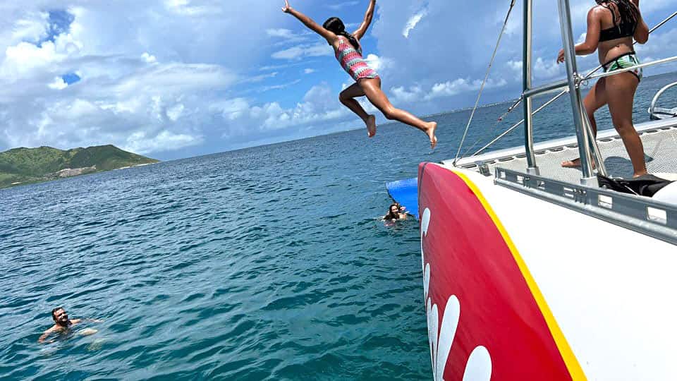 Girl jumps off Scoobi catamaran into the water