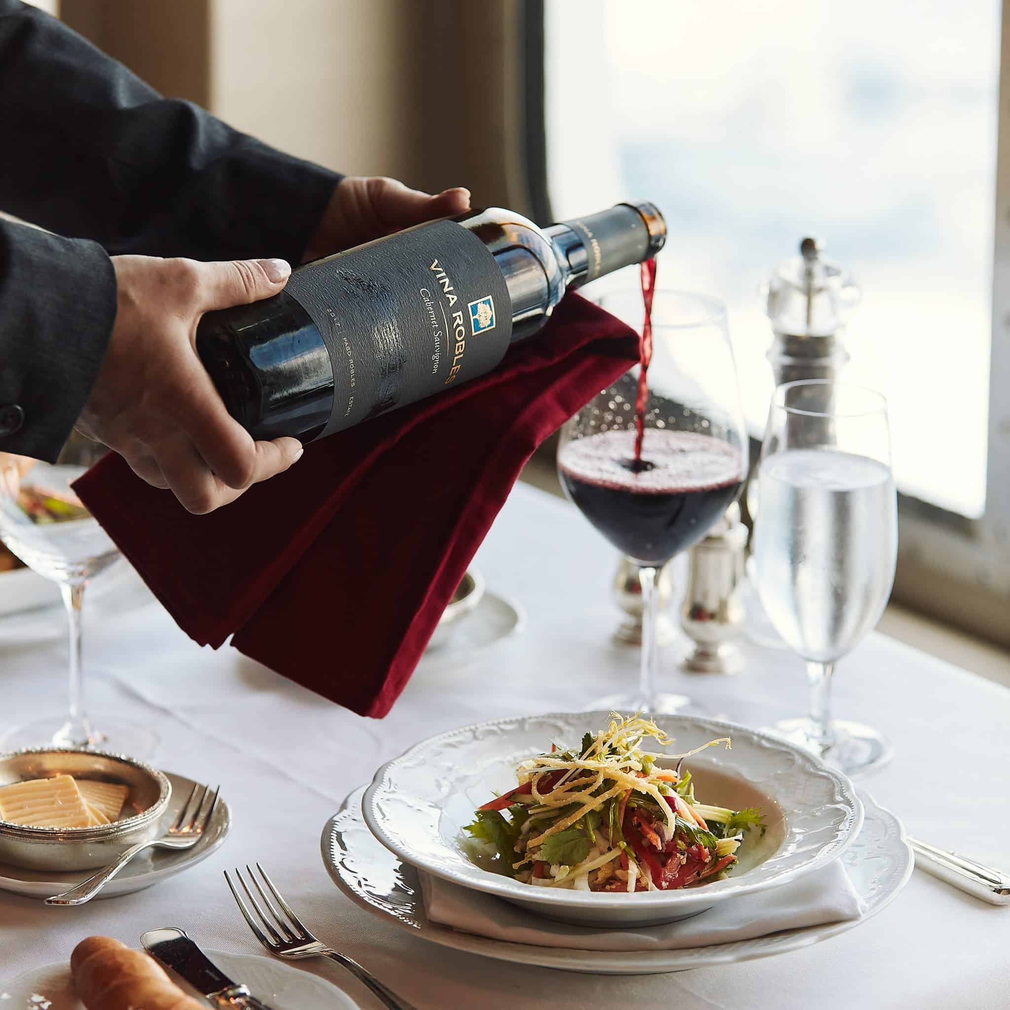 Red wine being poured for dinner at the Waterside restaurant on Crystal Serenity
