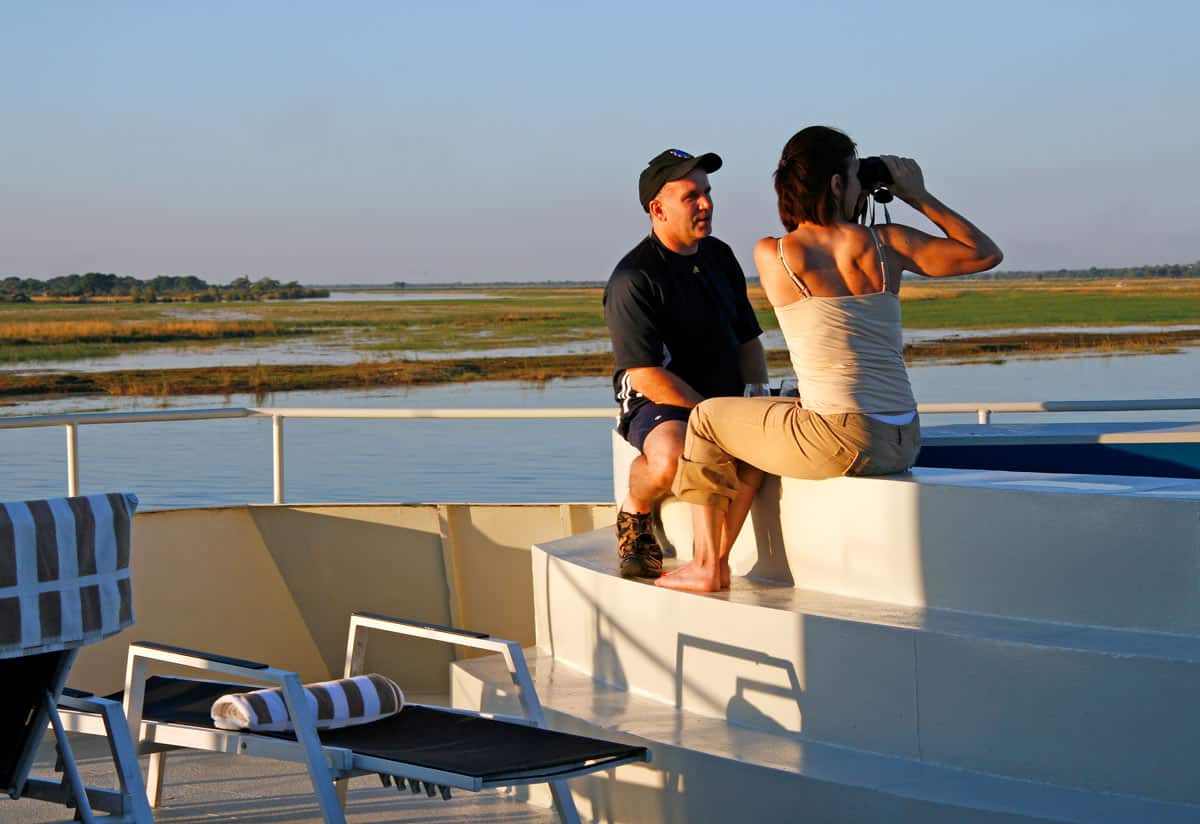 A couple watches elephants from the hot tub on the Zambezi Queen