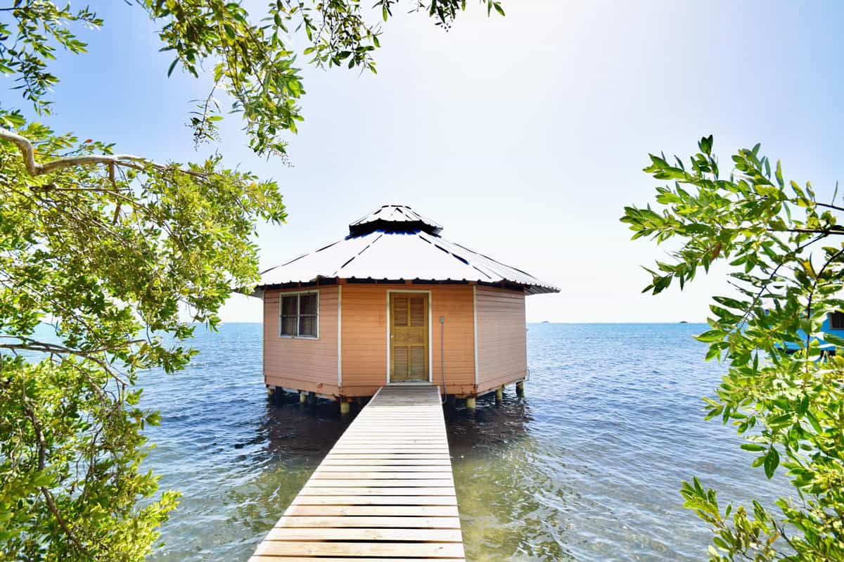 One of Mango Creek Resort's simple overwater huts on the water in Roatan