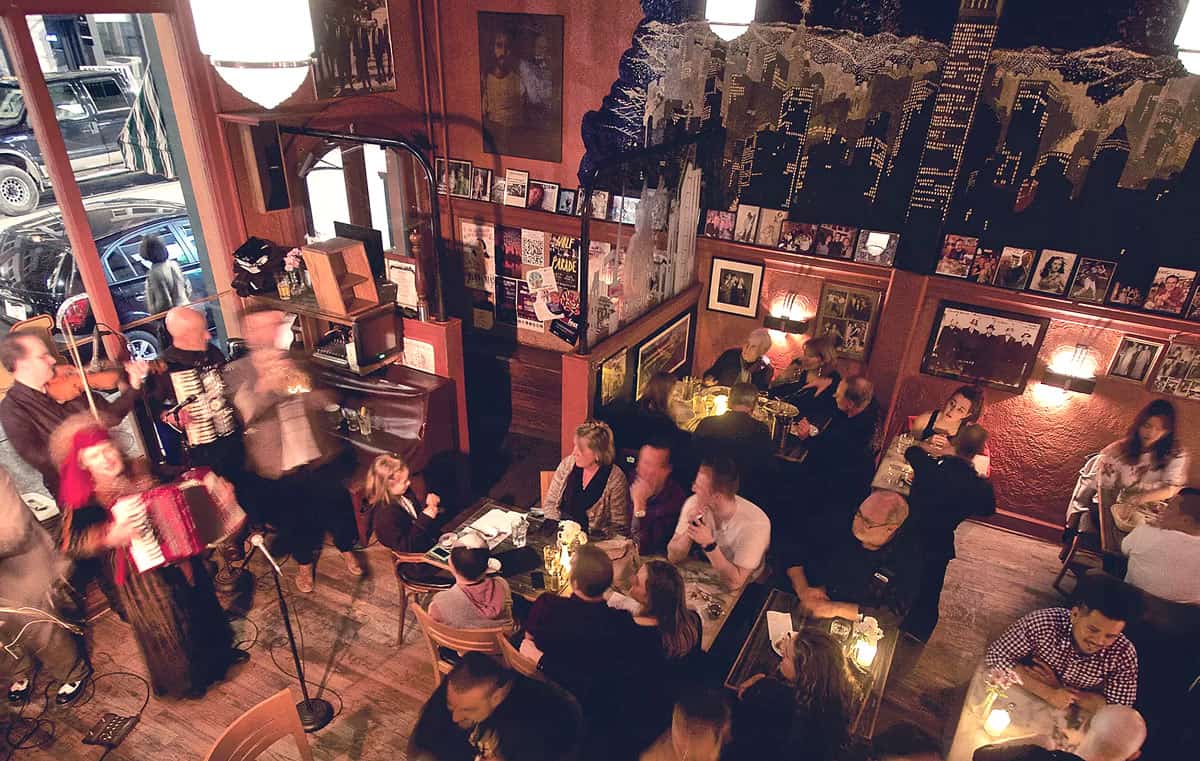Diners inside cozy restaurant with live music