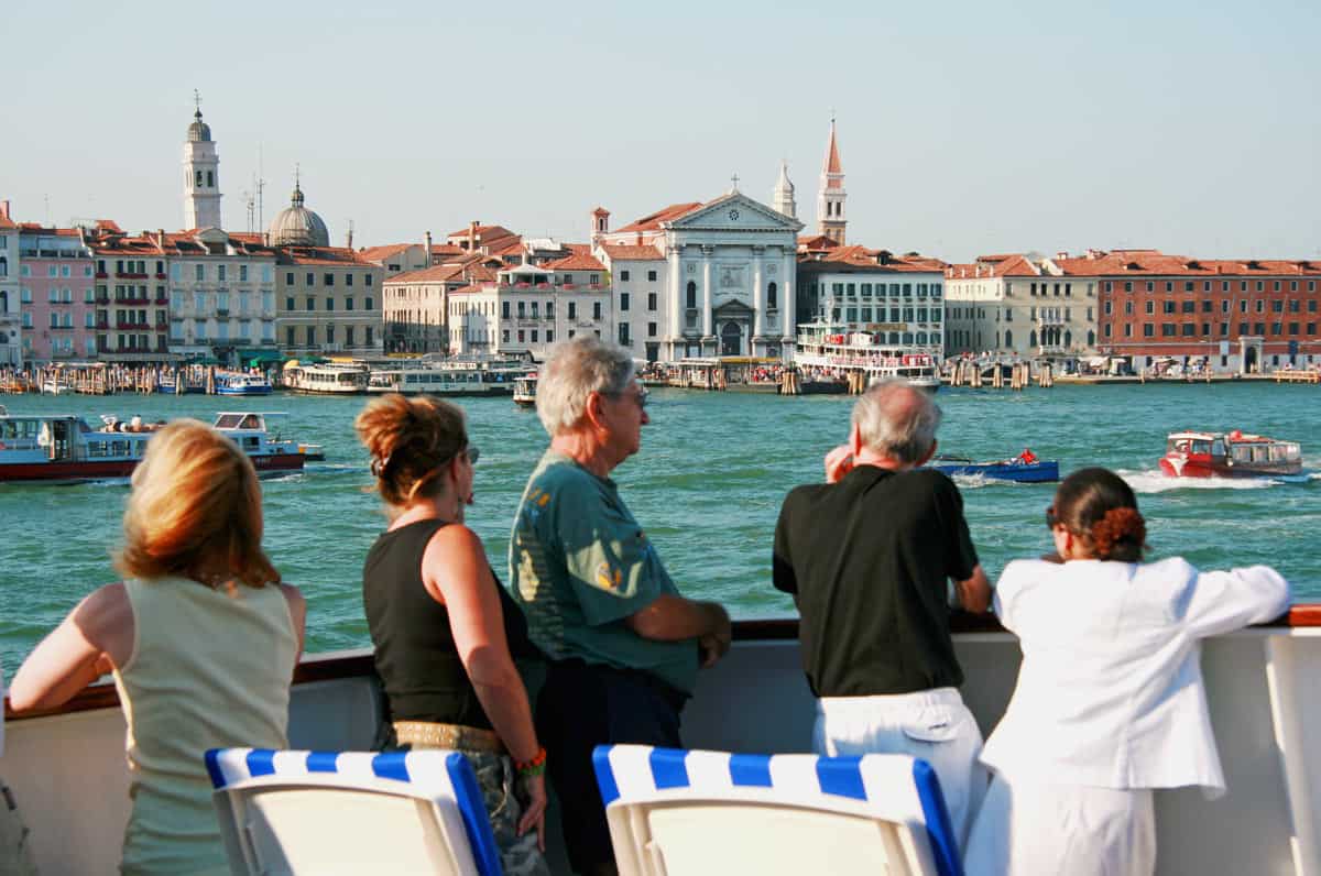 Passengers view Venice from a small cruise ship