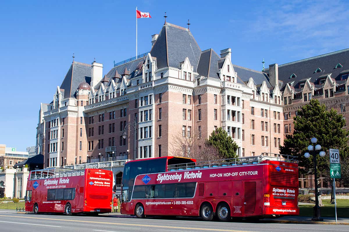 Two bright red double-decker Butchart Gardens Express Shuttle buses