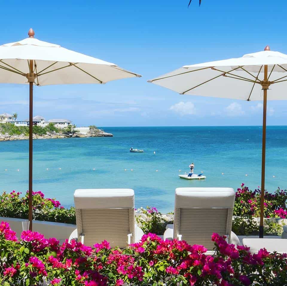 Two pool chairs facing the blue Caribbean sea