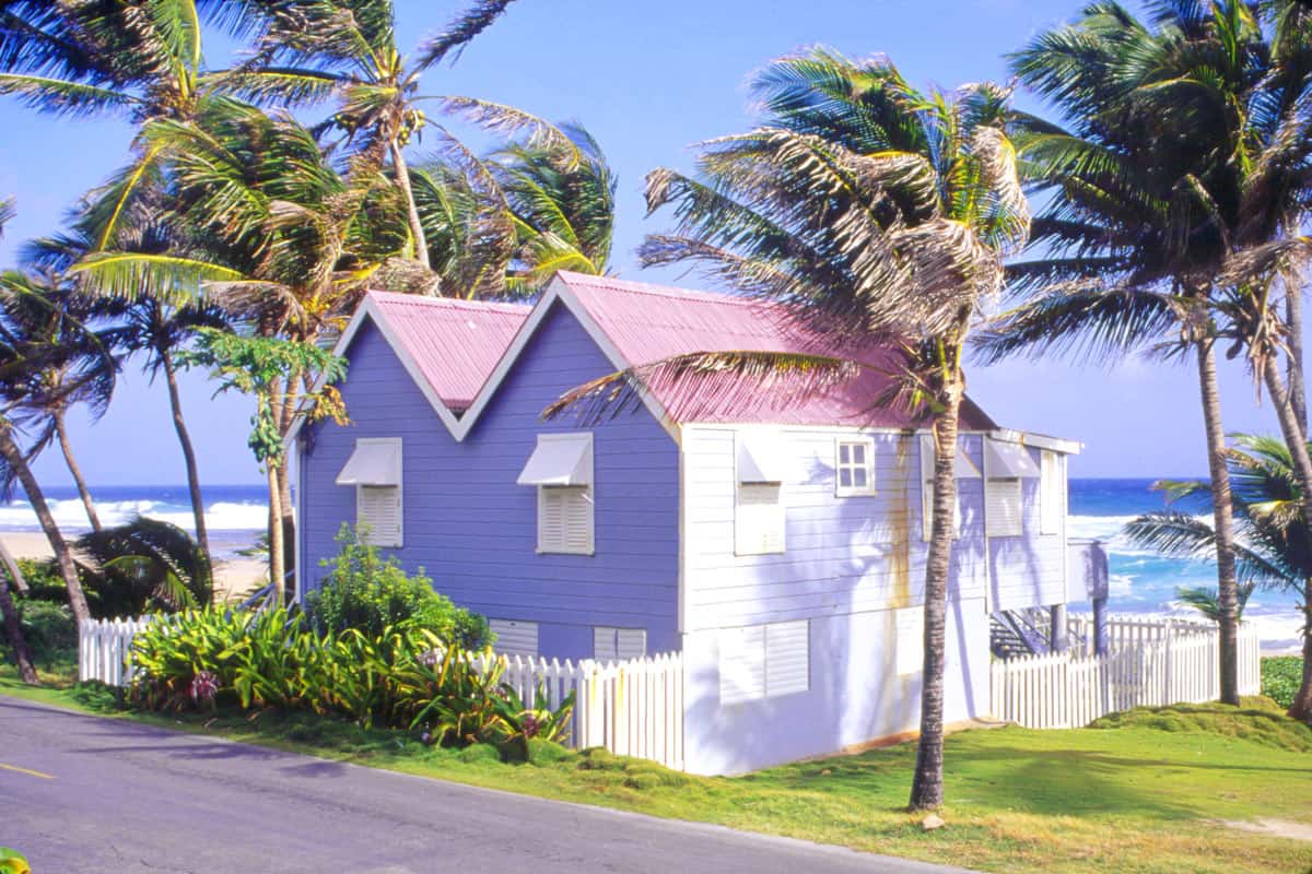 Mauve chattel house on beach in Barbados