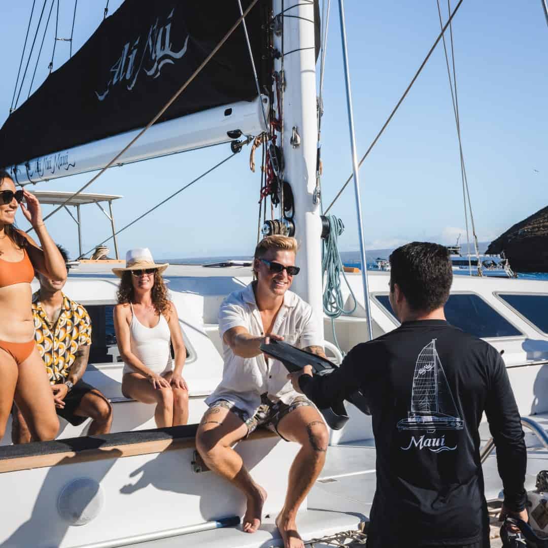 Crew on Alii Nui hands out snorkeling gear