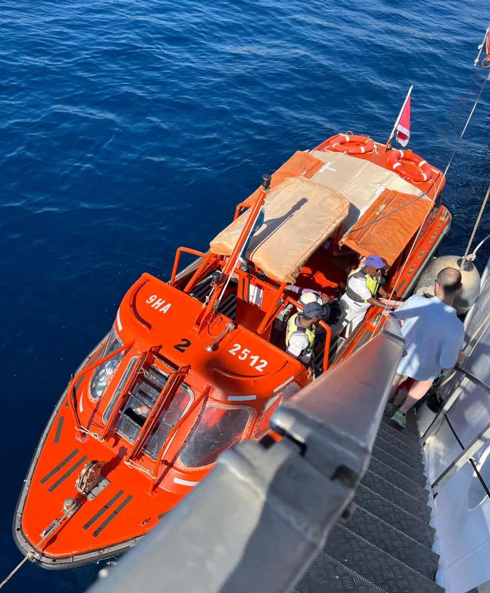 Guests climb down the gangplank to hop into the Star Flyer's tender.