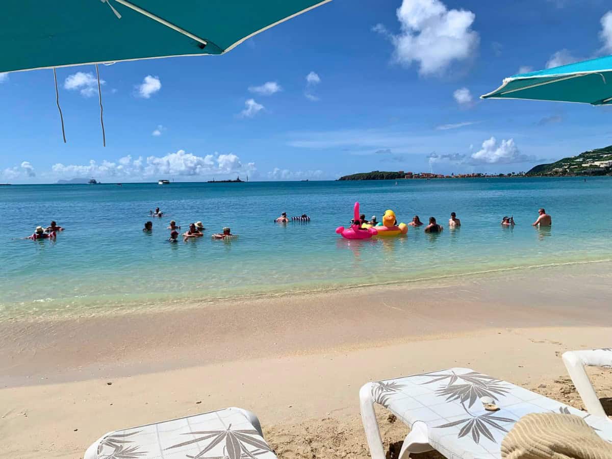 Lazy beach vibes at Big Bastard’s Beach Bar on Great Bay Beach – floaties, calm water and all
